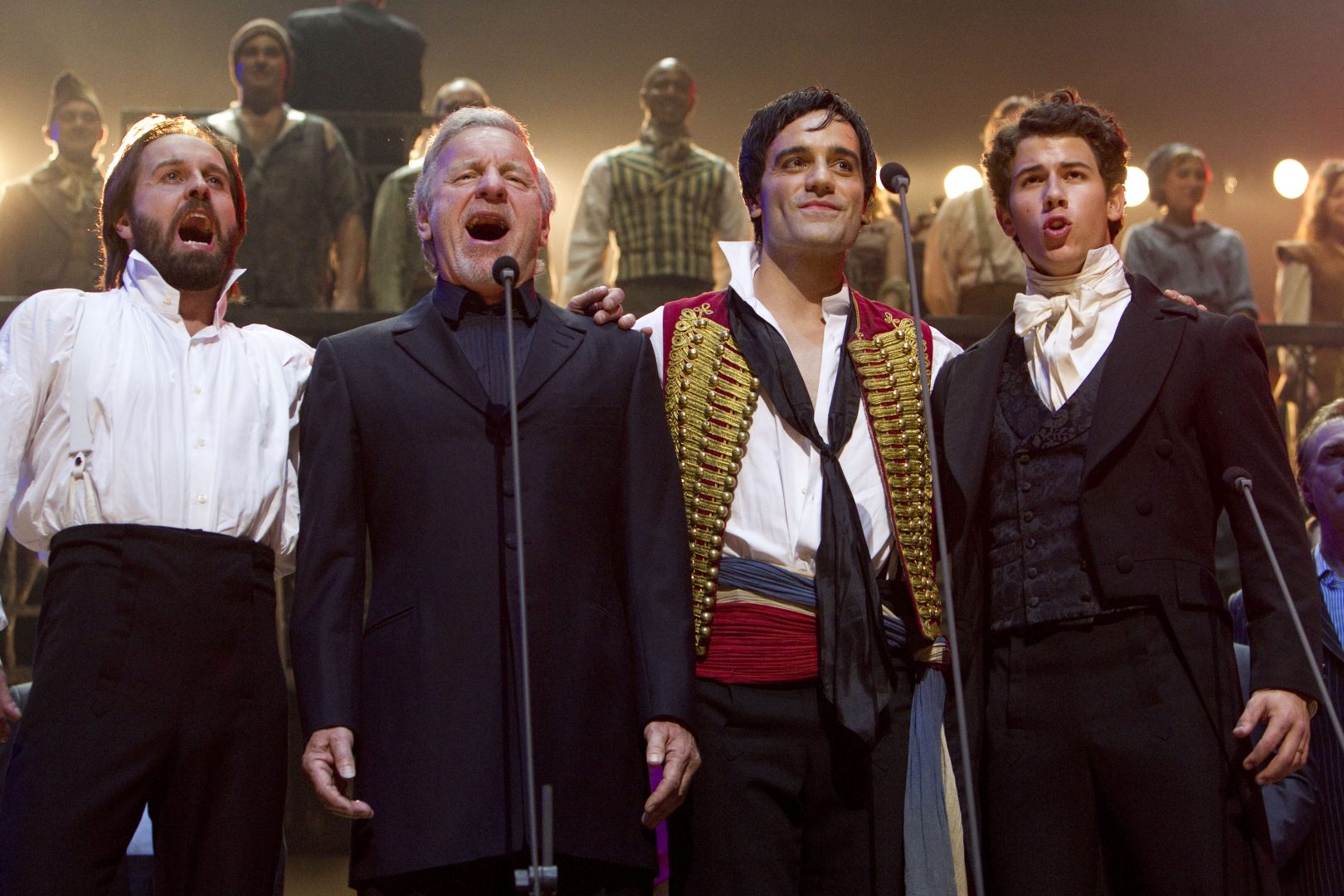 Alfie Boe (Jean Valjean), Colm Wilkinson (Jean Valjean), Ramin Karimloo (Enjolras) and Nick Jonas (Marius) during the curtain call for the Les Miserables 25th Anniversary Concert at The O2 Arena, London, England on the 3rd October 2010. (Credit should read: Dan Wooller/wooller.com). Paid use only. No Syndication