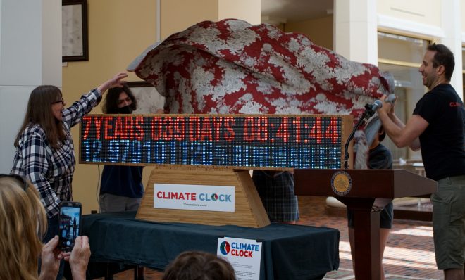 Karen Feridun, co-founder of the Better Path Coalition, left, and Greg Schwedock,  head of product and technology
of Climate Clock, unveil the climate clock that will sit at the capitol for the rest of the legislative session. The clock was unveiling at a Pennsylvania Climate Convergence press conference in the East Wing of the Capitol complex on Monday, June 13, 2022
