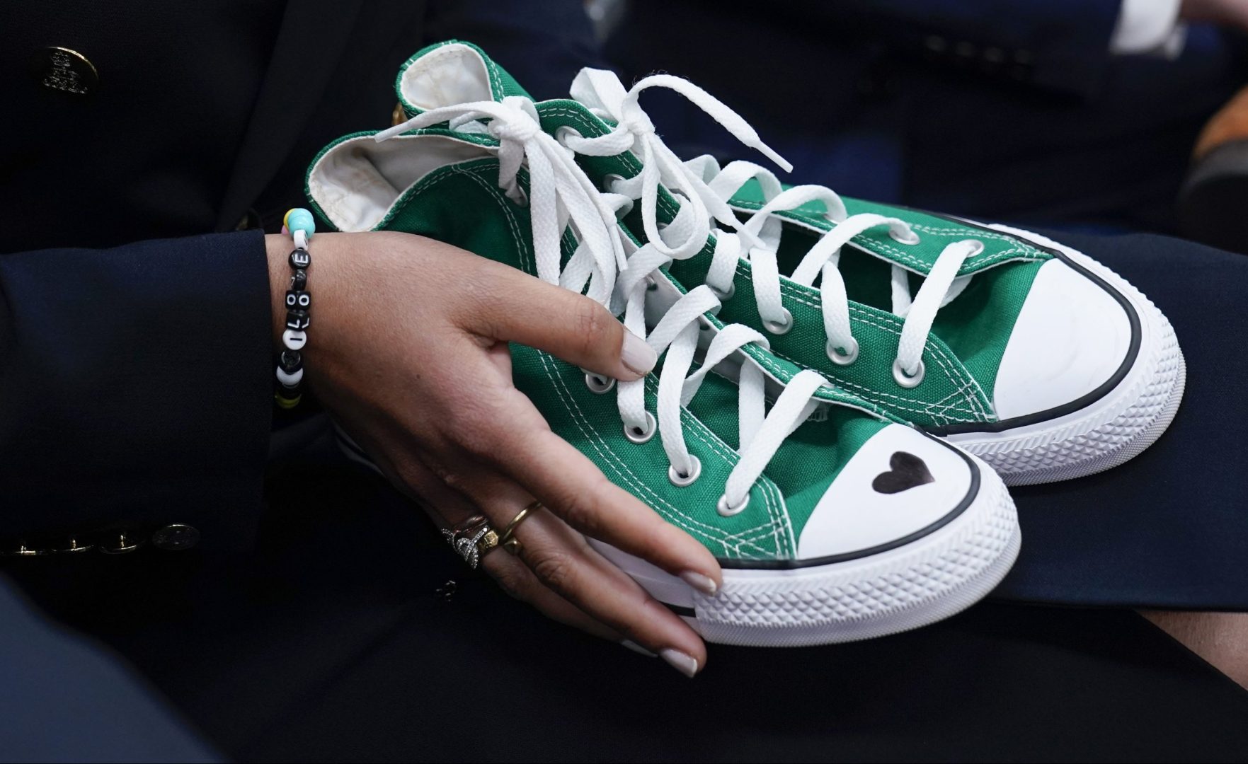 Camila Alves McConaughey holds the lime green Converse tennis shoes that were worn by Uvalde shooting victim Maite Yuleana Rodriguez, 10, as Matthew McConaughey, a native of Uvalde, Texas, joins White House press secretary Karine Jean-Pierre for the daily briefing at the White House in Washington, Tuesday, June 7, 2022. 