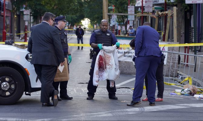 Philadelphia Police investigators work the scene of a fatal overnight shooting on South Street in Philadelphia, Sunday, June 5, 2022.