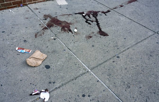 Blood is seen at the scene of a fatal overnight shooting on South Street in Philadelphia, Sunday, June 5, 2022