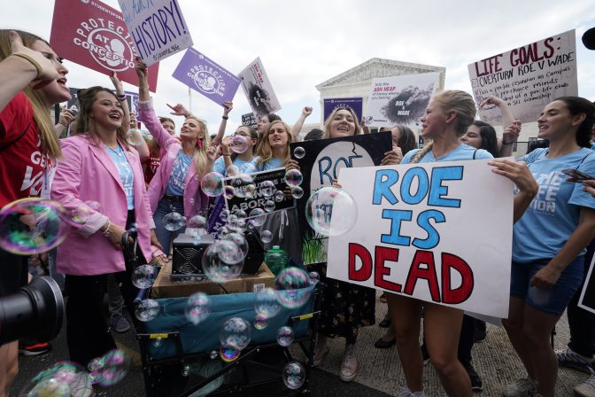 A celebration outside the Supreme Court, Friday, June 24, 2022, in Washington. The Supreme Court has ended constitutional protections for abortion that had been in place nearly 50 years — a decision by its conservative majority to overturn the court's landmark abortion cases.