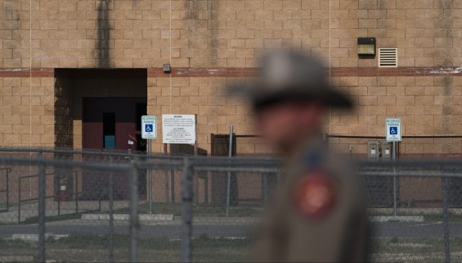 A back door at Robb Elementary School, where a gunman entered through to get into a classroom in last week's shooting, is seen in the distance in Uvalde, Texas, Monday, May 30, 2022.