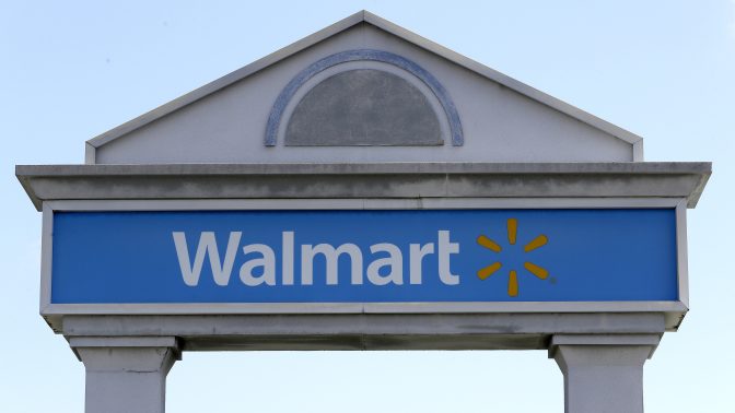 In this Sept. 3, 2019, file photo, a Walmart logo forms part of a sign outside a Walmart store, in Walpole, Mass. Walmart workers who once unloaded trucks now have a chance to drive them.