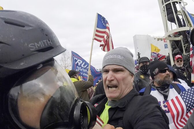 In this Jan. 6, 2021, image from video, Alan William Byerly, center, is seen attacking an Associated Press photographer during a riot at the U.S. Capitol in Washington.