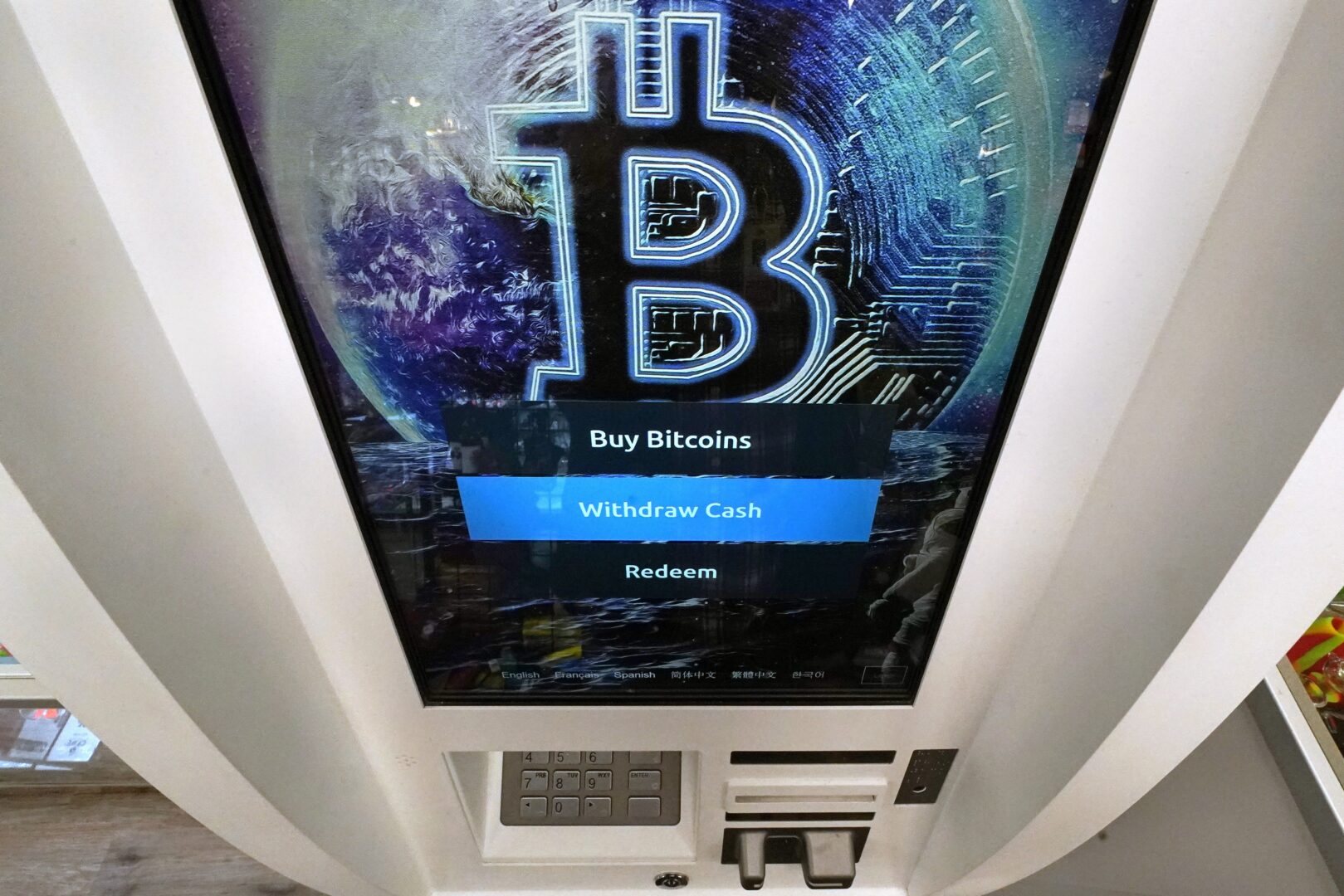 In this Feb. 9, 2021, photo, the Bitcoin logo appears on the display screen of a cryptocurrency ATM at a store in Salem, N.H. California on Wednesday, May 4, 2022. 