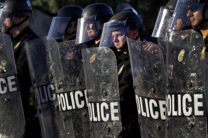 Phoenix Police officers watch protesters rally on June 2, 2020, in Phoenix during demonstrations over the death of George Floyd.