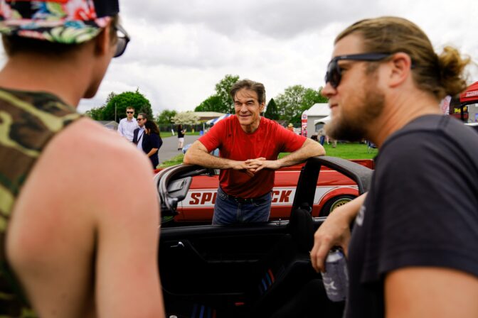 Mehmet Oz, Republican candidate for U.S. Senate in Pennsylvania, meets with attendees during a visit to a car show in Carlisle, Pa., May 14, 2022.