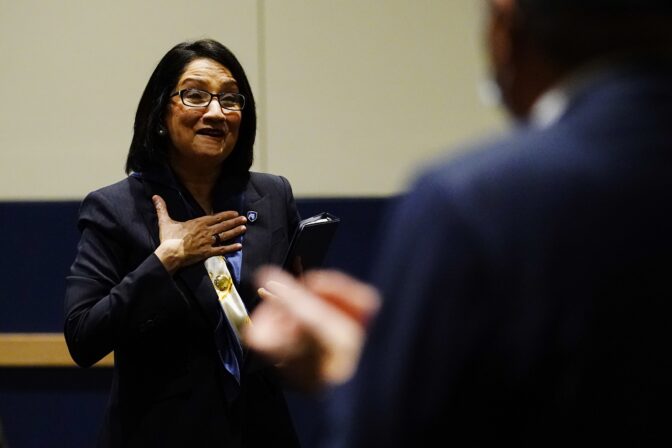 Neeli Bendapudi walks into the audience after speaking during a meeting of the Penn State Board of Trustees, Thursday, Dec. 9, 2021, in State College, Pa.