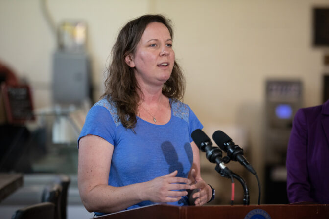Jennie O'Neil, owner of Knead Pizza, speaks at a press conference in Harrisburg.
