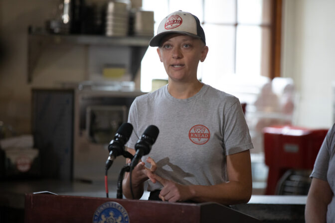 Knead Pizza team manager Jessie Pierce speaks at a press conference in Harrisburg