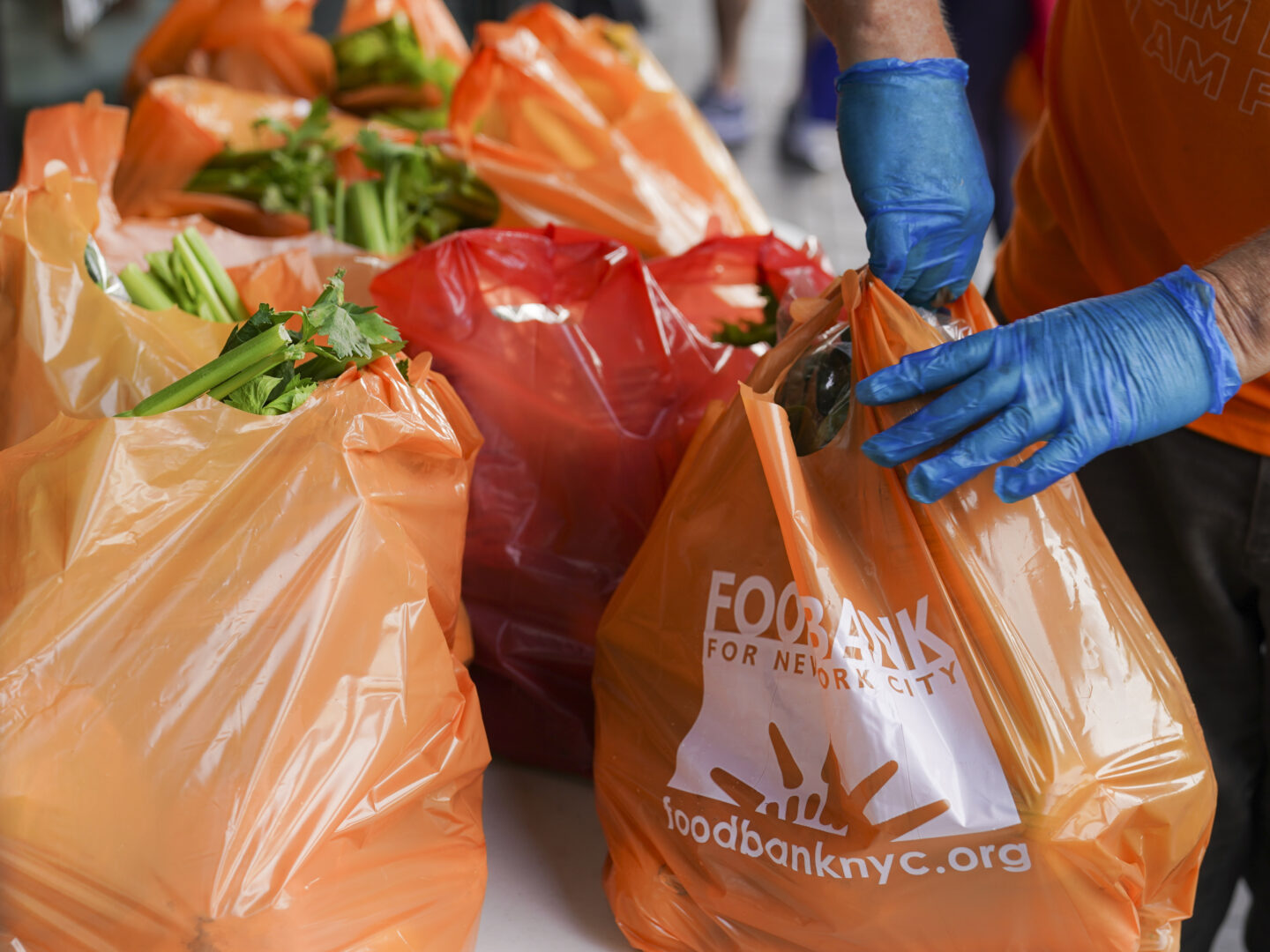 Fresh produce and shelf-stable pantry items are bagged for collection outside Barclays Center as Food Bank For New York City provides assistance to those in need due to the COVID-19 pandemic, Thursday, Sept. 10, 2020, in New York. 