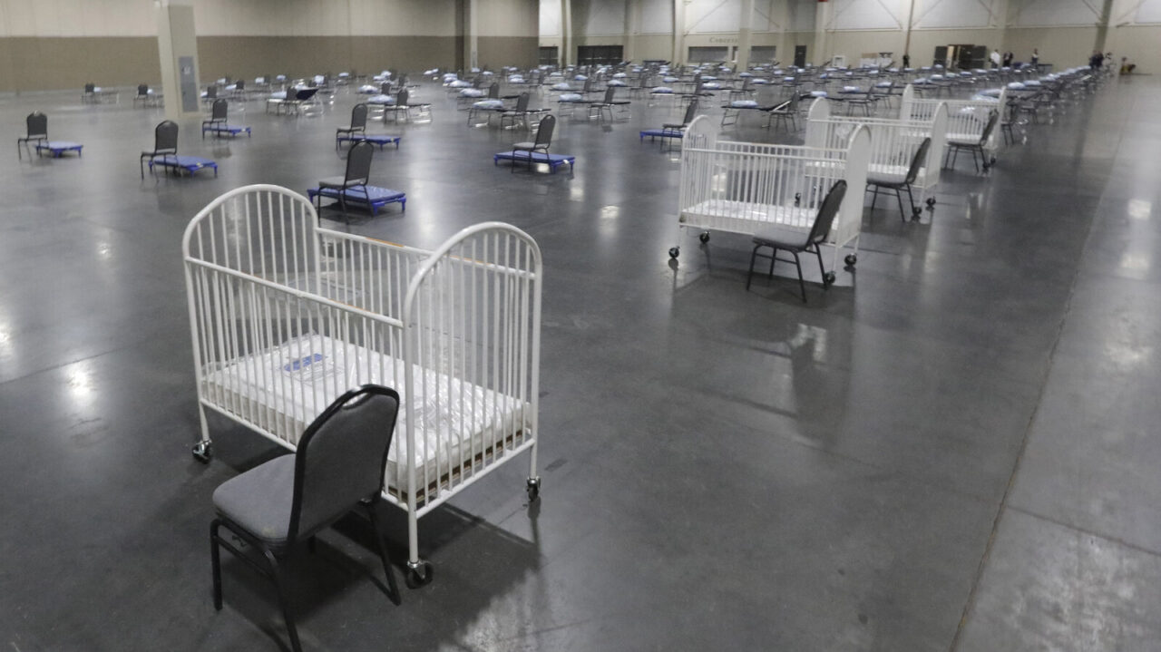 FILE - Cots and cribs are arranged at the Mountain America Expo Center in Sandy, Utah, on April 6, 2020, as an alternate care site or for hospital overflow amid the COVID-19 pandemic. According to a National Center for Health Statistics report released on Wednesday, Feb. 23, 2022, maternal mortality rates for U.S. women climbed higher in the pandemic's first year, continuing a trend that disproportionately affects Black mothers. (AP Photo/Rick Bowmer, File)
