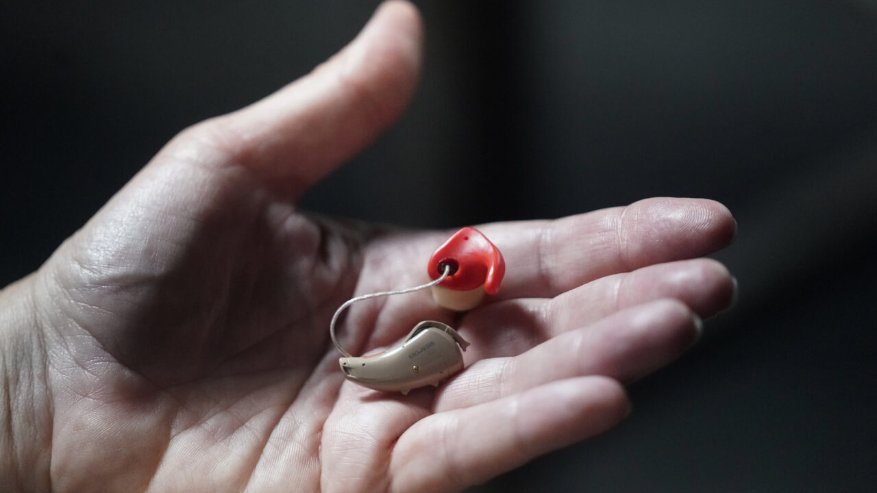 Chelle Wyatt holds her hearing aid Friday, April 15, 2022, in Salt Lake City. People with hearing loss have adopted technology to navigate the world, especially as hearing aids are expensive and inaccessible to many.  (AP Photo/Rick Bowmer)