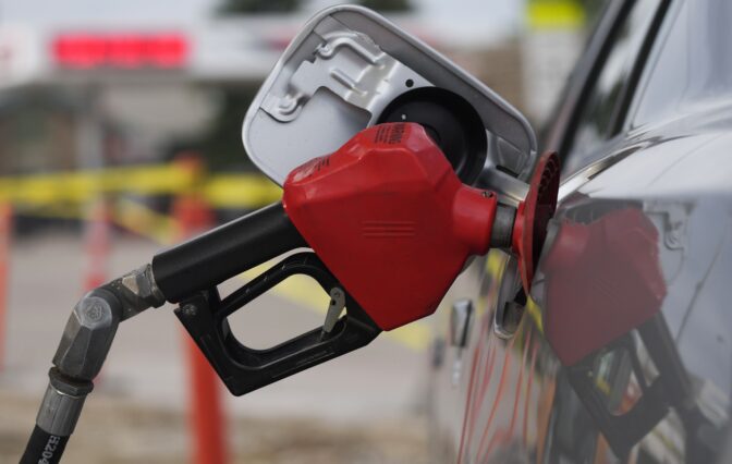 A motorist fills up the tank on a sedan, on July 22, 2022, in Saratoga, Wyo. Gasoline prices are sliding back toward the $4 mark for the first time in more than five months — good news for consumers who are struggling with high prices for many other essentials.