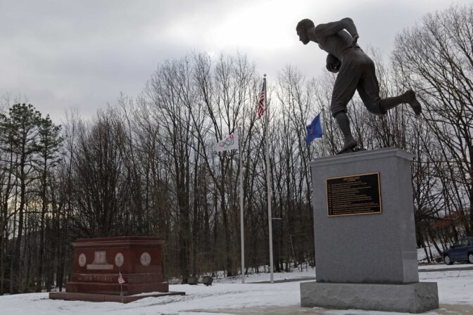 In this photo taken on Tuesday, Jan. 12, 2010, Jim Thorpe's tomb, left, and a statue of him, right, are shown in Jim Thorpe, Pa.