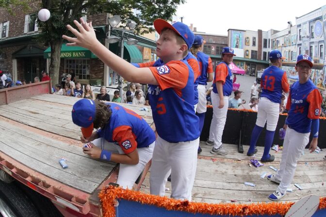 The Great Lakes Region champion Little League team from Hagerstown, Indiana, rides in the Little League Grand Slam Parade in downtown Williamsport, Pa., on Monday, Aug. 15, 2022. The Little League World Series baseball tournament, featuring 20 teams from around the world, starts Wednesday in South Williamsport, Pa. (