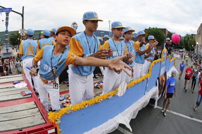 The West Region champion Little League team from Honolulu rides in the Little League Grand Slam Parade in downtown Williamsport, Pa., Monday, Aug. 15, 2022.