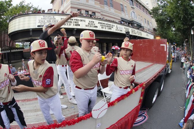 The Mountain Region champion Little League team from Santa Clara, Utah, rides in the Little League Grand Slam Parade in downtown Williamsport, Pa., Monday, Aug. 15, 2022.