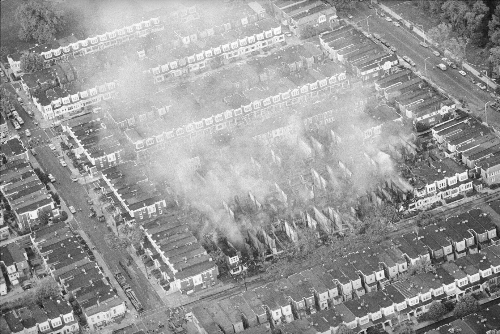 Smoke rises from the ashes of a West Philadelphia neighborhood, May 4, 1985, the morning after a siege between Philadelphia police and members of the radical group MOVE left 11 people dead and 61 homes destroyed. 