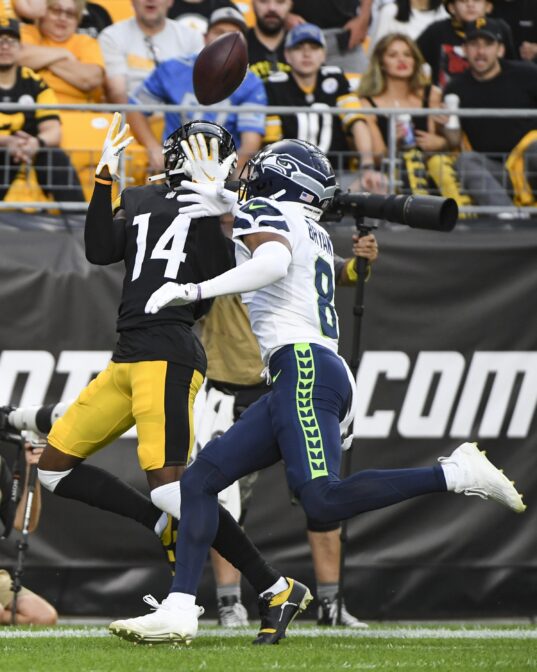 Pittsburgh Steelers wide receiver George Pickens (14) makes a touchdown catch as Seattle Seahawks cornerback Coby Bryant (8) defends during the first half of a preseason NFL football game, Saturday, Aug. 13, 2022, in Pittsburgh.