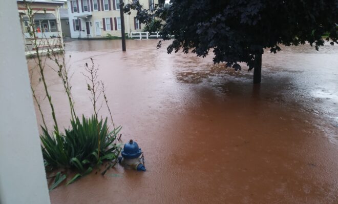 Floodwater fills the Sharp family's front yard in Middletown on July 23, 2017.