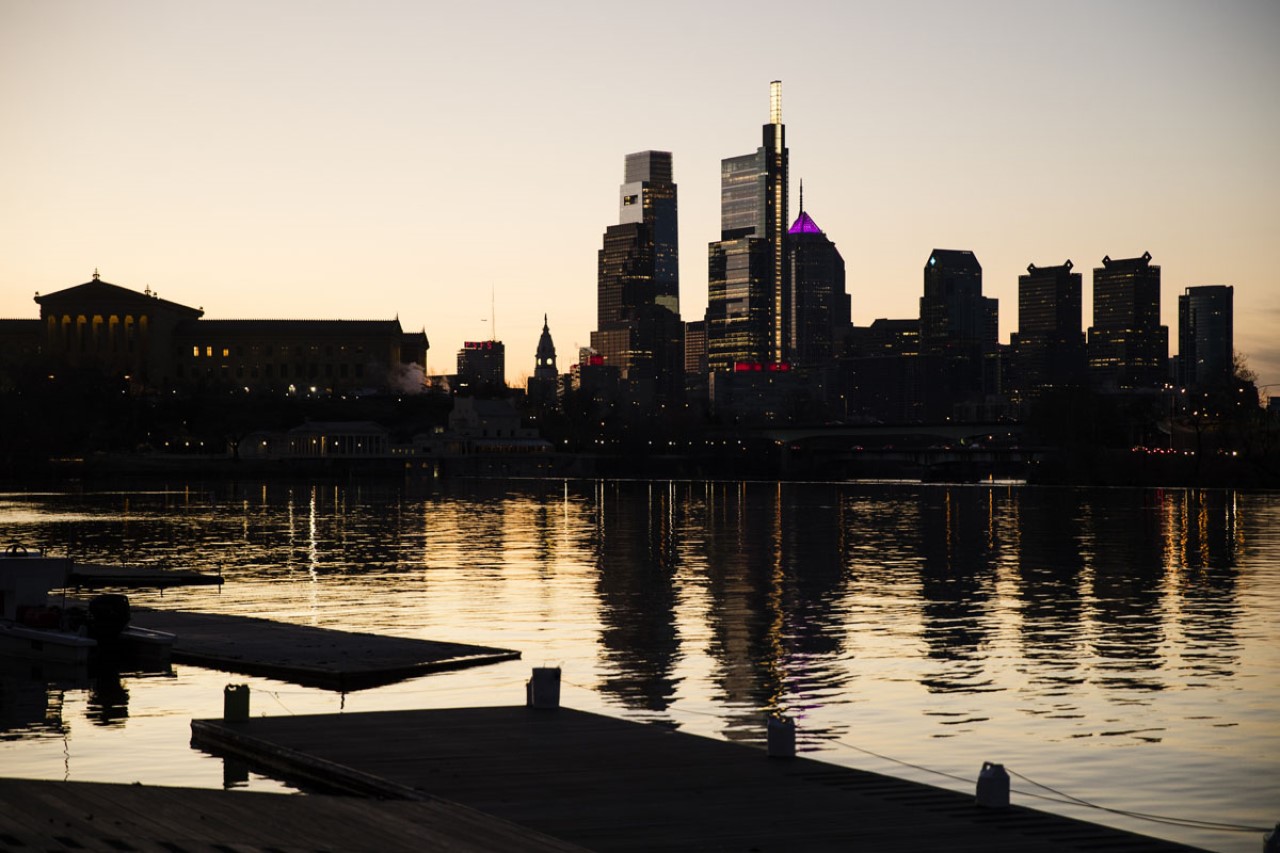 The skyline is reflected in the Schuylkill River as the sun rises over Philadelphia. 