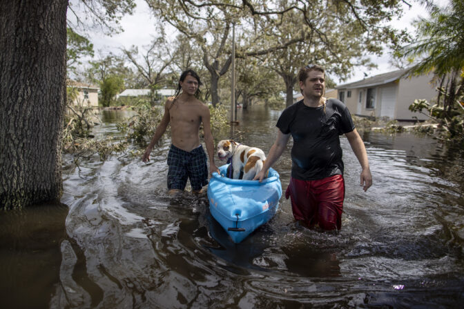 People leave the flooded community of Country Club Ridge in North Port Florida after hurricane Ian 