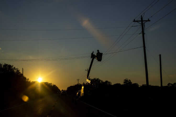 Crews work on a power lines near Ona Florida, after Hurricane Ian, October 1, 2022. 