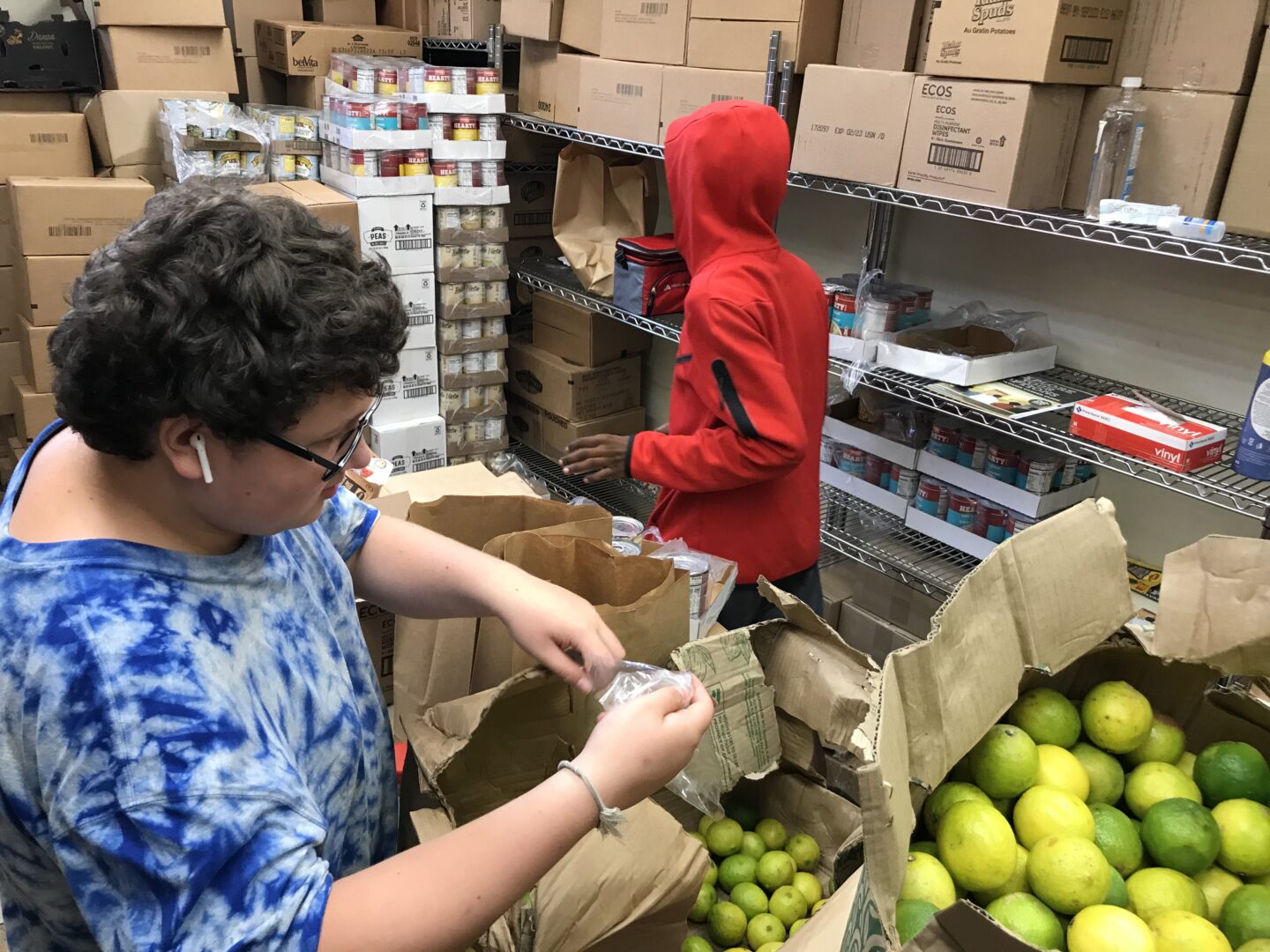 Volunteers sort produce at United Neighborhood Centers' pantry.
