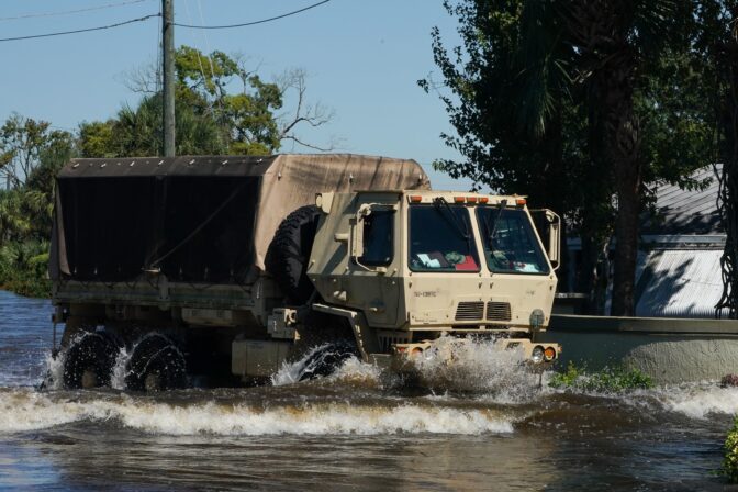 A National Guard truck drives through flood waters at the Good Samaritan Society Village, following Hurricane Ian, on September 30, 2022 in Kissimmee, Florida. 
