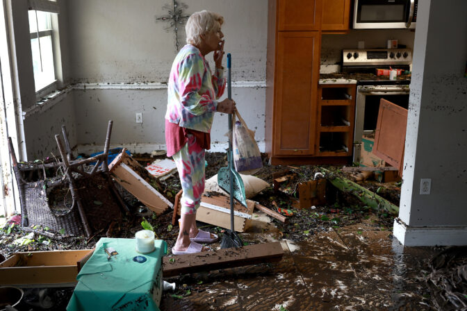 Stedi Scuderi looks over her apartment after flood water inundated it when Hurricane Ian passed through