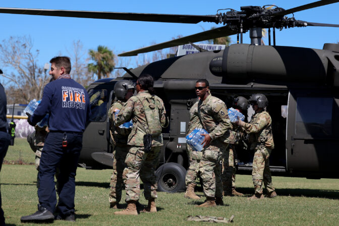Florida Army National Guard members unload supplies from a helicopter on October 02, 2022 in Pine Island, Florida. 