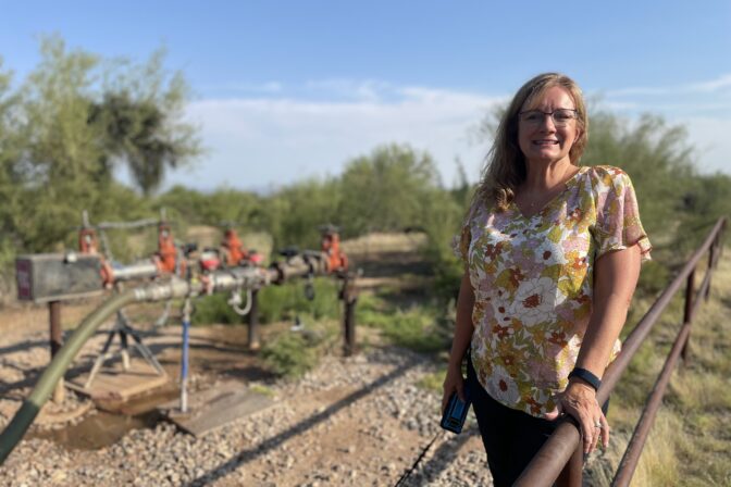 Karen Nabity poses outside of her home in Phoenix where she'll soon be cut off from the Colorado River.
