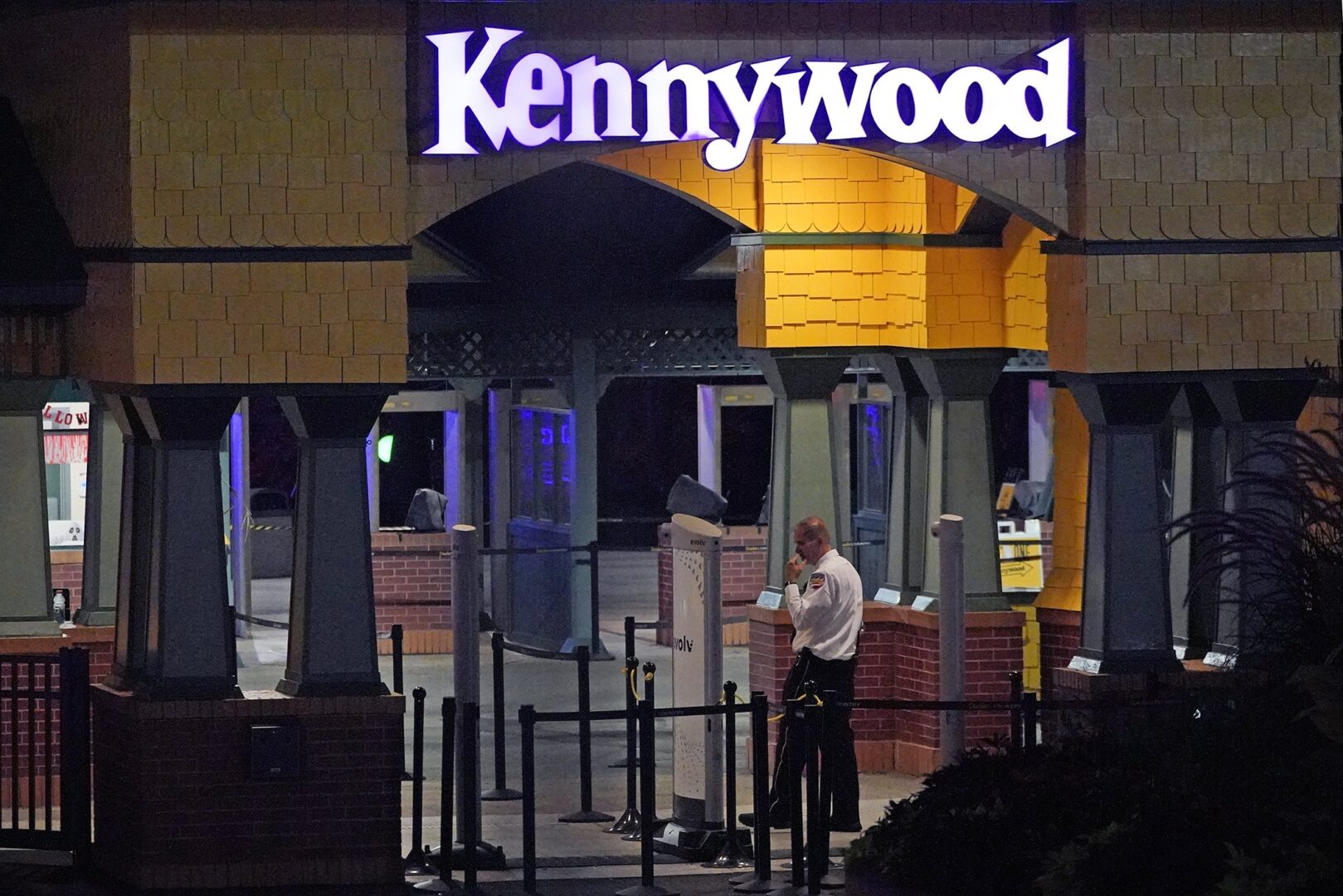 A Kennywood Park security guard stands at the main entrance to the amusement park in West Mifflin, Pa., early Sunday, Sept 25, 2022.  