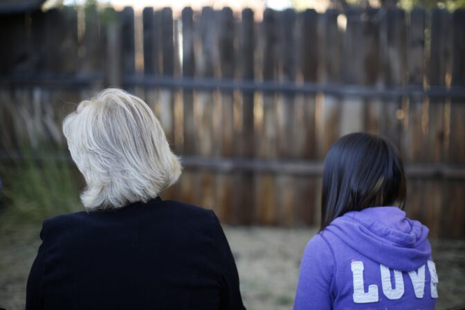 MJ and her adoptive mother sit for an interview in Sierra Vista, Ariz., Oct. 27, 2021. State authorities placed MJ in foster care after learning that her father, the late Paul Adams, sexually assaulted her and posted video of the assaults on the Internet.
