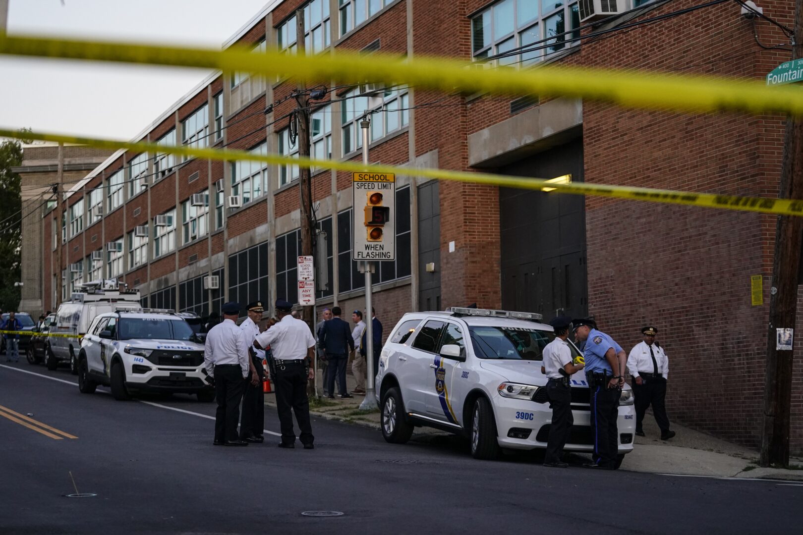 Investigators work the scene where multiple people were shot near a high school in Philadelphia, Tuesday, Sept. 27, 2022. 