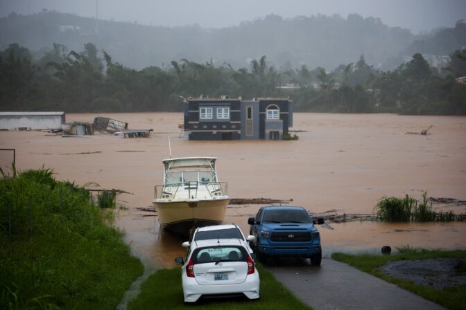 A home is submerged in floodwaters caused by Hurricane Fiona in Cayey, Puerto Rico, Sunday, Sept. 18, 2022. According to authorities three people were inside the home and were reported to have been rescued.