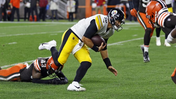Pittsburgh Steelers quarterback Mitch Trubisky (10) slips the tackle of Cleveland Browns safety John Johnson III (43) and dives for the end zone for a touchdown during the first half of an NFL football game in Cleveland, Thursday, Sept. 22, 2022.