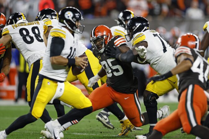 Cleveland Browns defensive end Myles Garrett (95) rushes Pittsburgh Steelers quarterback Mitch Trubisky (10) but can't get around James Daniels (78) during the first half of an NFL football game in Cleveland, Thursday, Sept. 22, 2022.