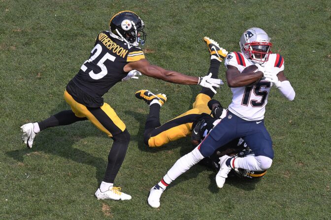 New England Patriots wide receiver Nelson Agholor (15) gets away from Pittsburgh Steelers cornerback Ahkello Witherspoon (25) and Cameron Sutton, rear, after making a catch during the second half of an NFL football game in Pittsburgh, Sunday, Sept. 18, 2022.
