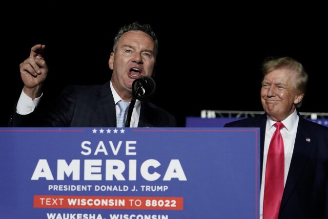 Wisconsin Republican gubernatorial candidate Tim Michels, left, speaks as former President Donald Trump, right, listens at a rally Aug. 5, 2022, in Waukesha, Wis.