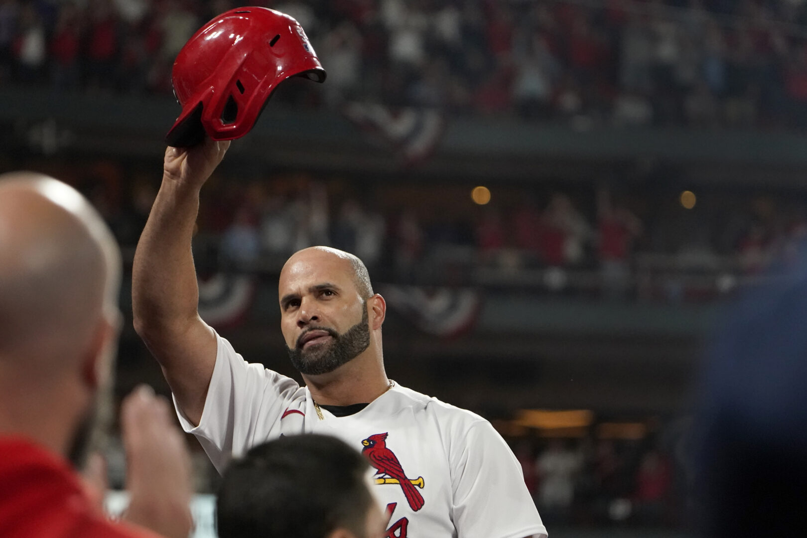 St. Louis Cardinals' Albert Pujols tips his cap after hitting a solo home run during the fourth inning of a baseball game against the Pittsburgh Pirates Friday, Sept. 30, 2022, in St. Louis. (AP Photo/Jeff Roberson)