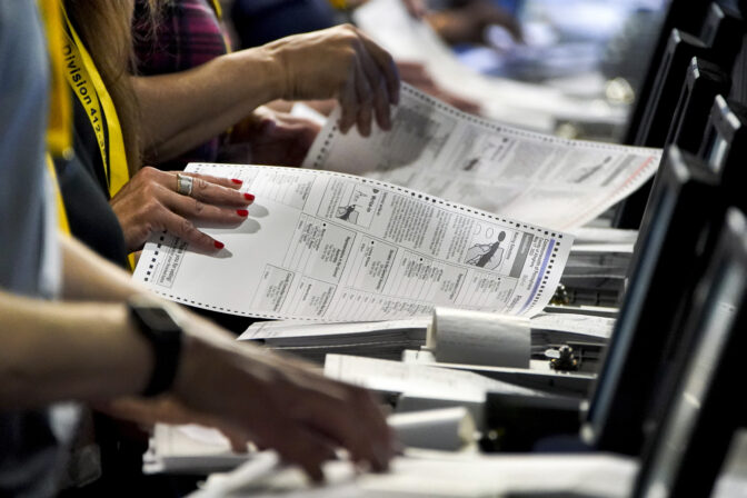 Election workers perform a recount of ballots from the recent Pennsylvania primary election at the Allegheny County Election Division warehouse