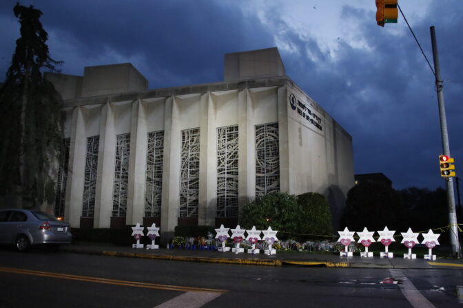 A memorial of flowers and stars line a sidewalk outside the Tree of Life Synagogue in Pittsburgh, on Sunday, Oct. 28, 2018,