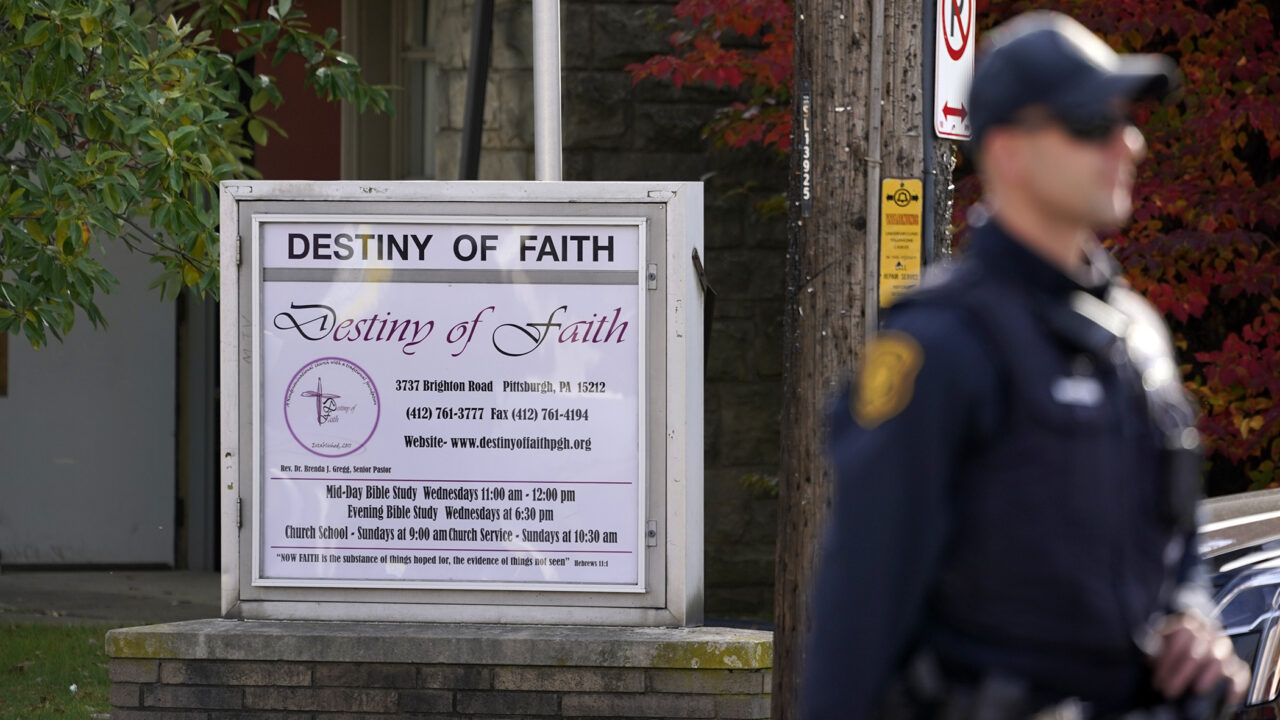 A Pittsburgh police officer stands outside the Destiny of Faith Church in Pittsburgh,