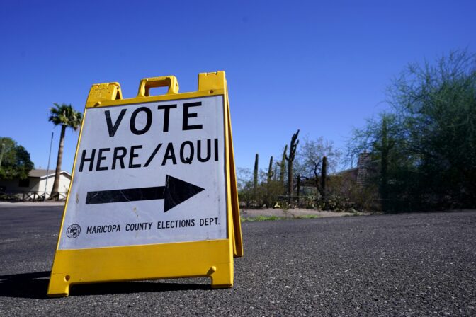 A sign marks the entrance to a voting precinct on the first day of early voting in the general election in Phoenix, Wednesday, Oct. 12, 2022.