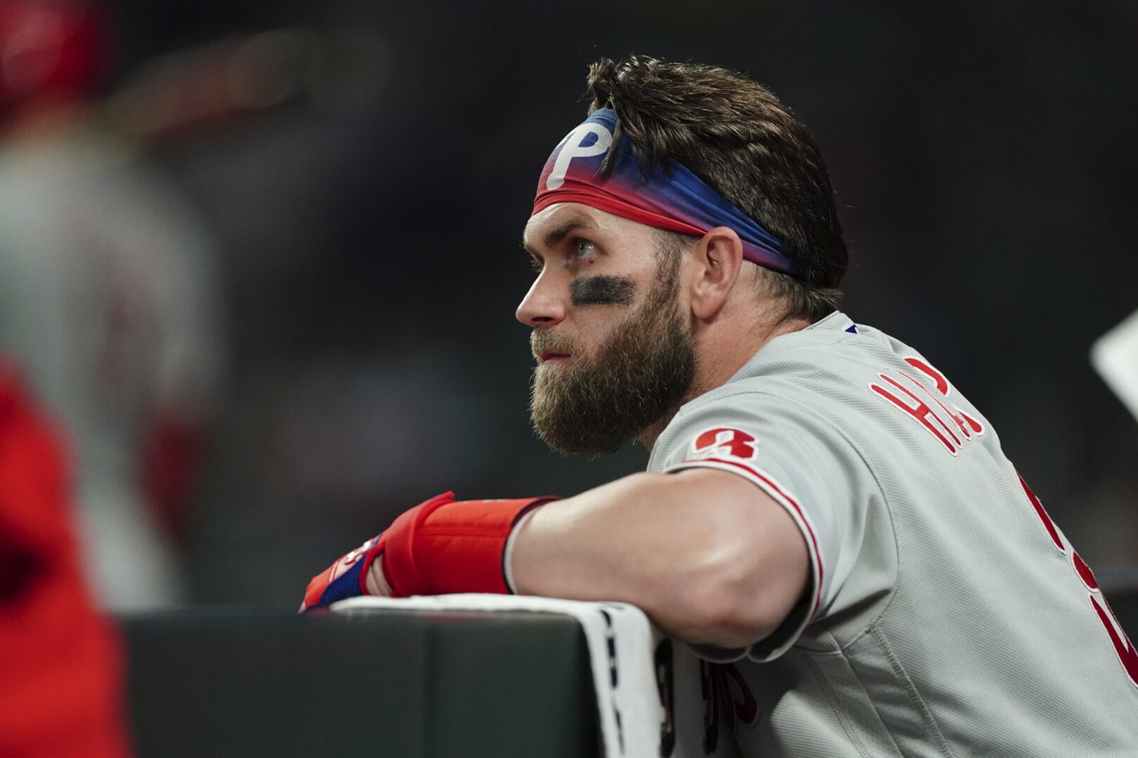 Philadelphia Phillies designated hitter Bryce Harper (3) watches play from the dugout during the seventh inning in Game 2 of baseball's National League Division Series between the Atlanta Braves and the Philadelphia Phillies, Wednesday, Oct. 12, 2022, in Atlanta. (