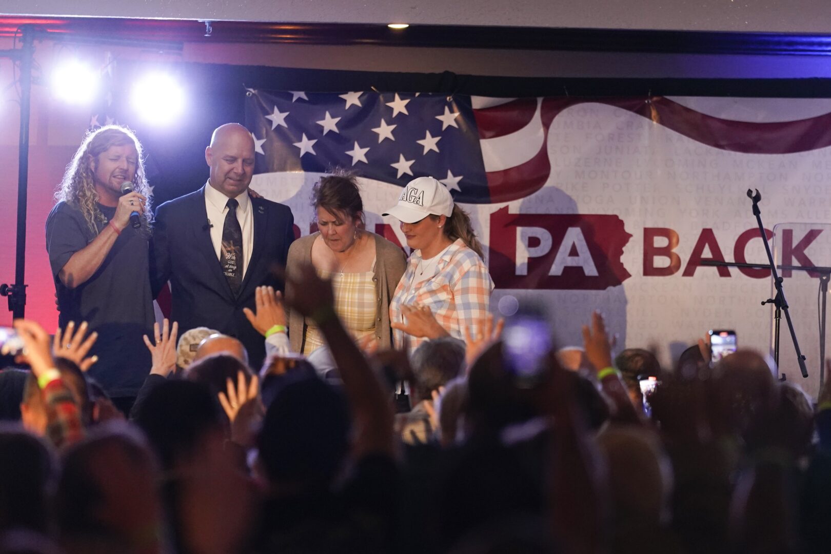 State Sen. Doug Mastriano, R-Franklin, a Republican candidate for Governor of Pennsylvania, stands on stage with Sean Feucht, left, his wife, Rebbeca, and Jenna Ellis, right, during a primary night election gathering in Chambersburg, Pa., Tuesday, May 17, 2022.