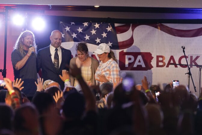 State Sen. Doug Mastriano, R-Franklin, a Republican candidate for Governor of Pennsylvania, stands on stage with Sean Feucht, left, his wife Rebbeca and Jenna Ellis, right, take part in a primary night election gathering in Chambersburg, Pa., Tuesday, May 17, 2022.